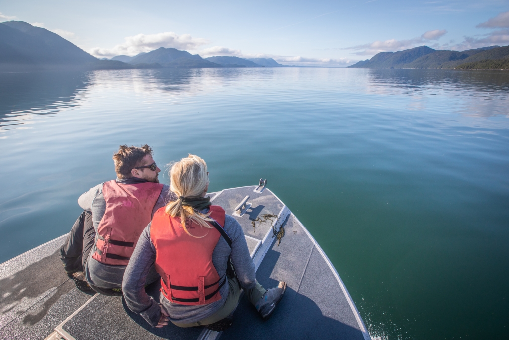 Guests on a boat looking at water at Spirit Bear Lodge