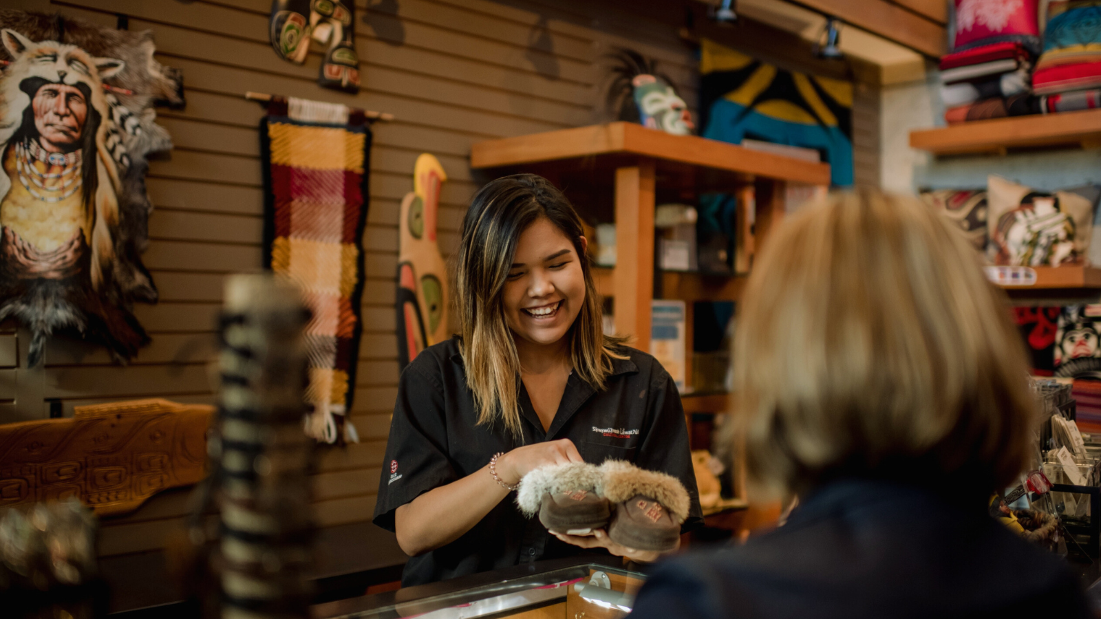 Indigenous staff at the Squamish Lil'wat Cultural Centre gift shop in Whistler, BC