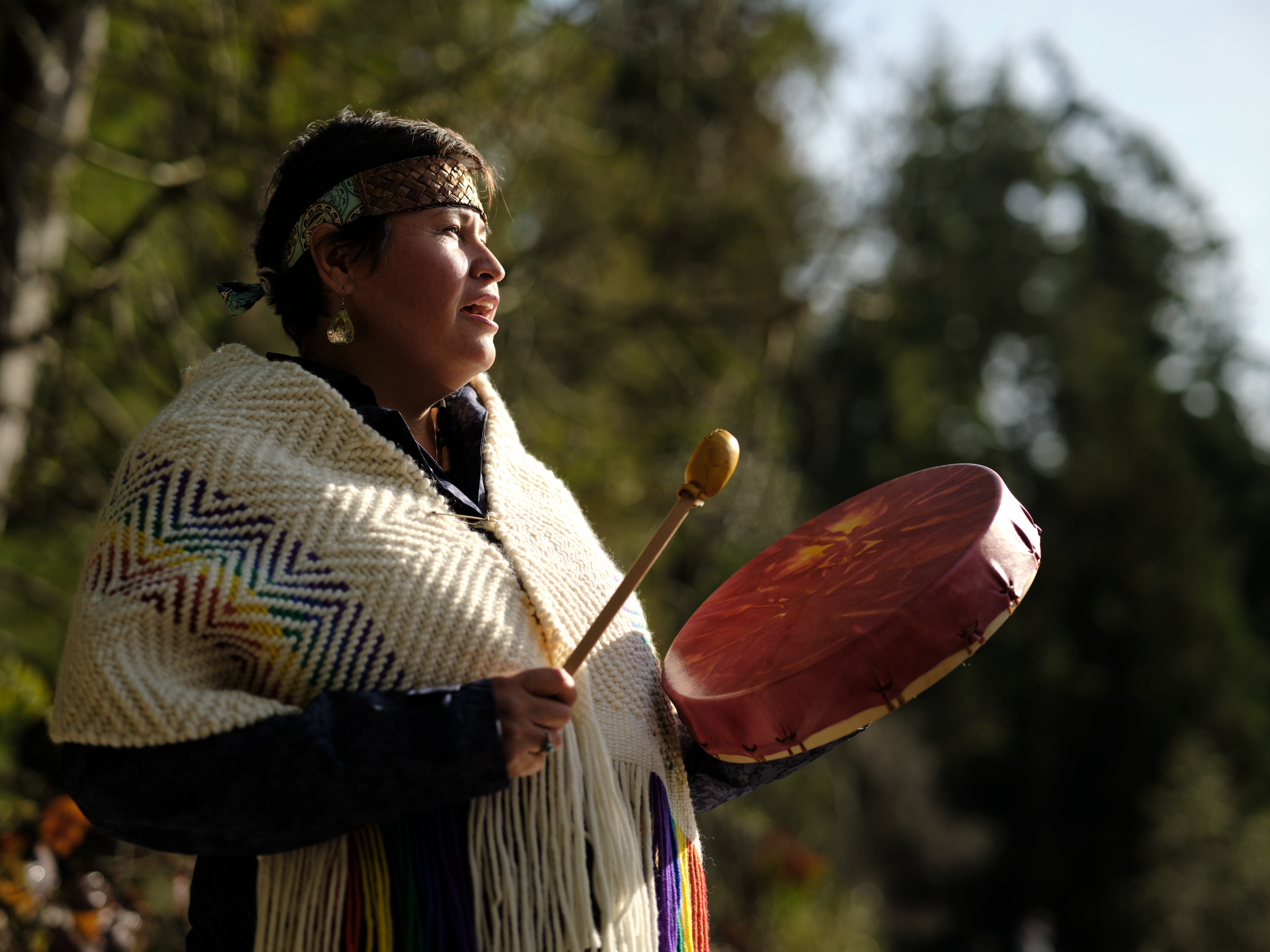 A woman beating a drum