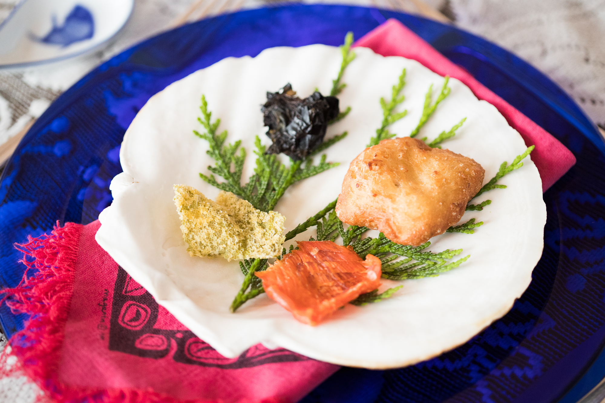 Indigenous food on a scallop shell being served at Haida House