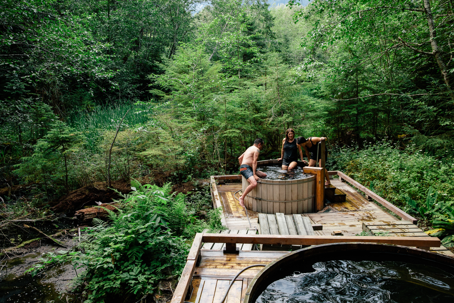 3 people getting into a hot tub