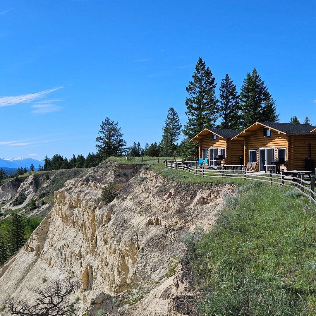 A cliff-side cabin view at The Raven's Nest Resort & Campground