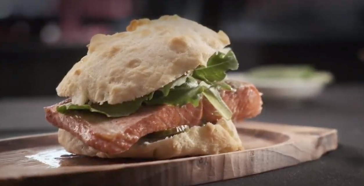 Fish sandwich on a wooden plate