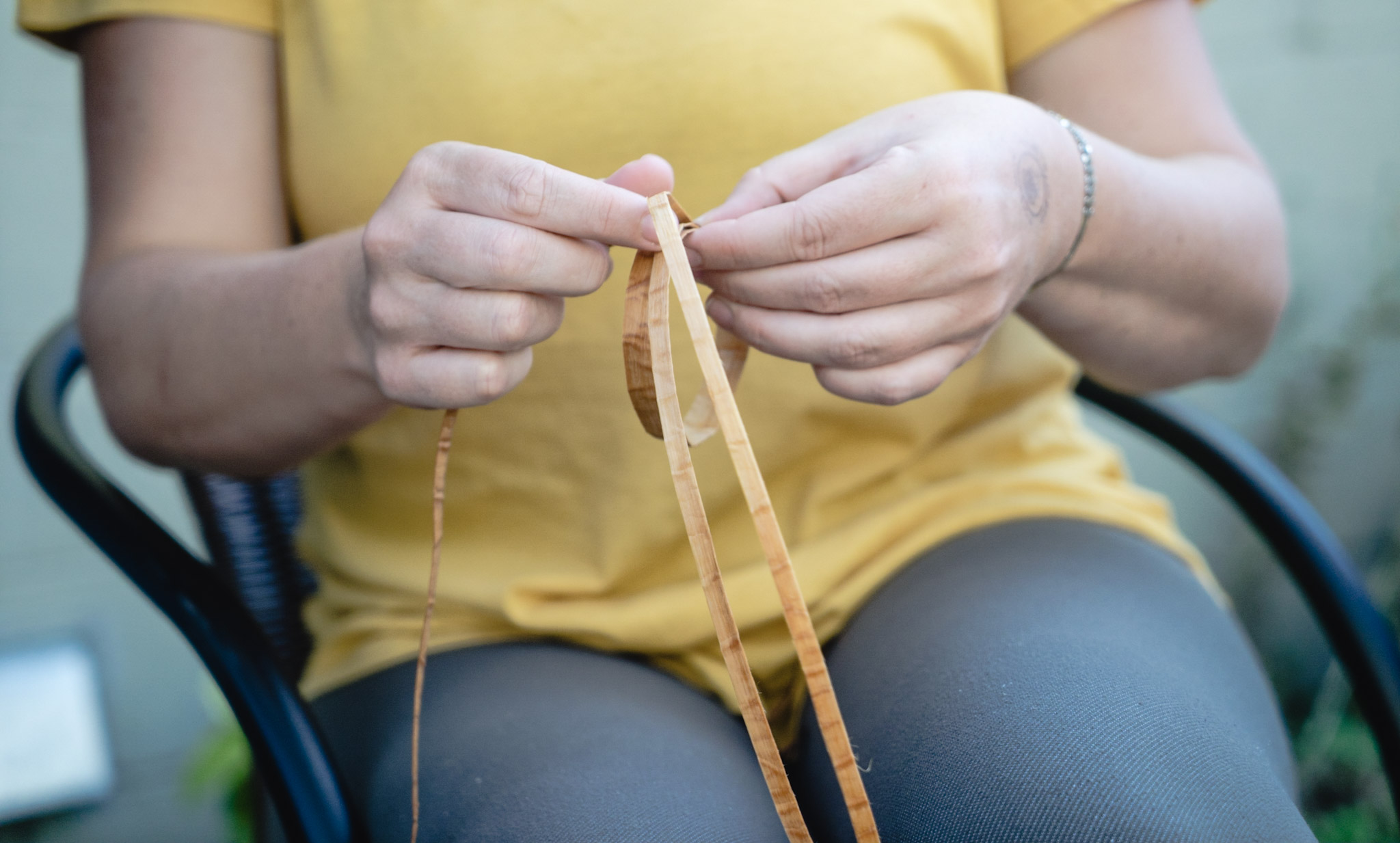 Woman weaving a Spapium Farm