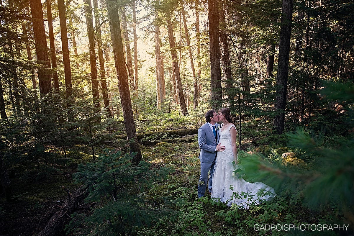 Wedding couple kissing in woods