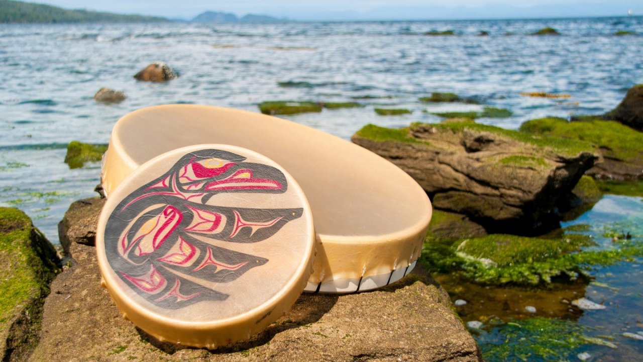 Two indigenous drums along the water