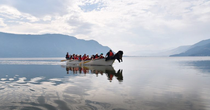 People in a boat on a very calm lake