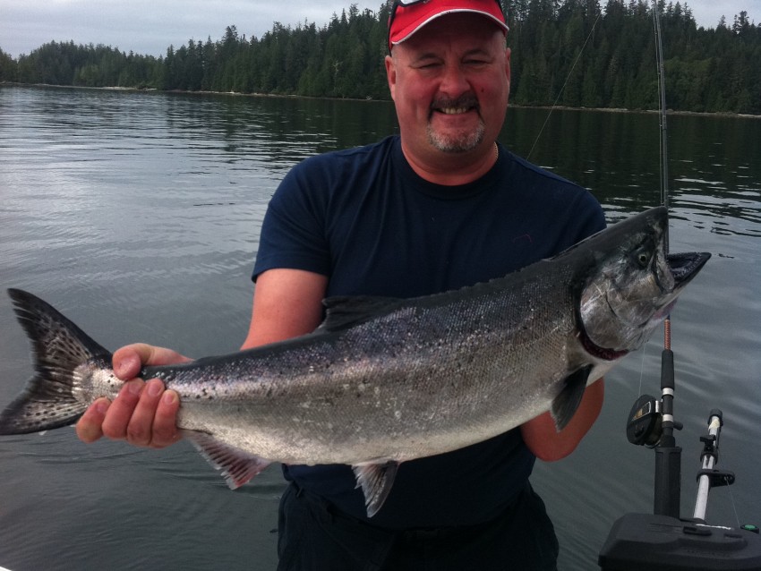 Man holding a salmon while fishing