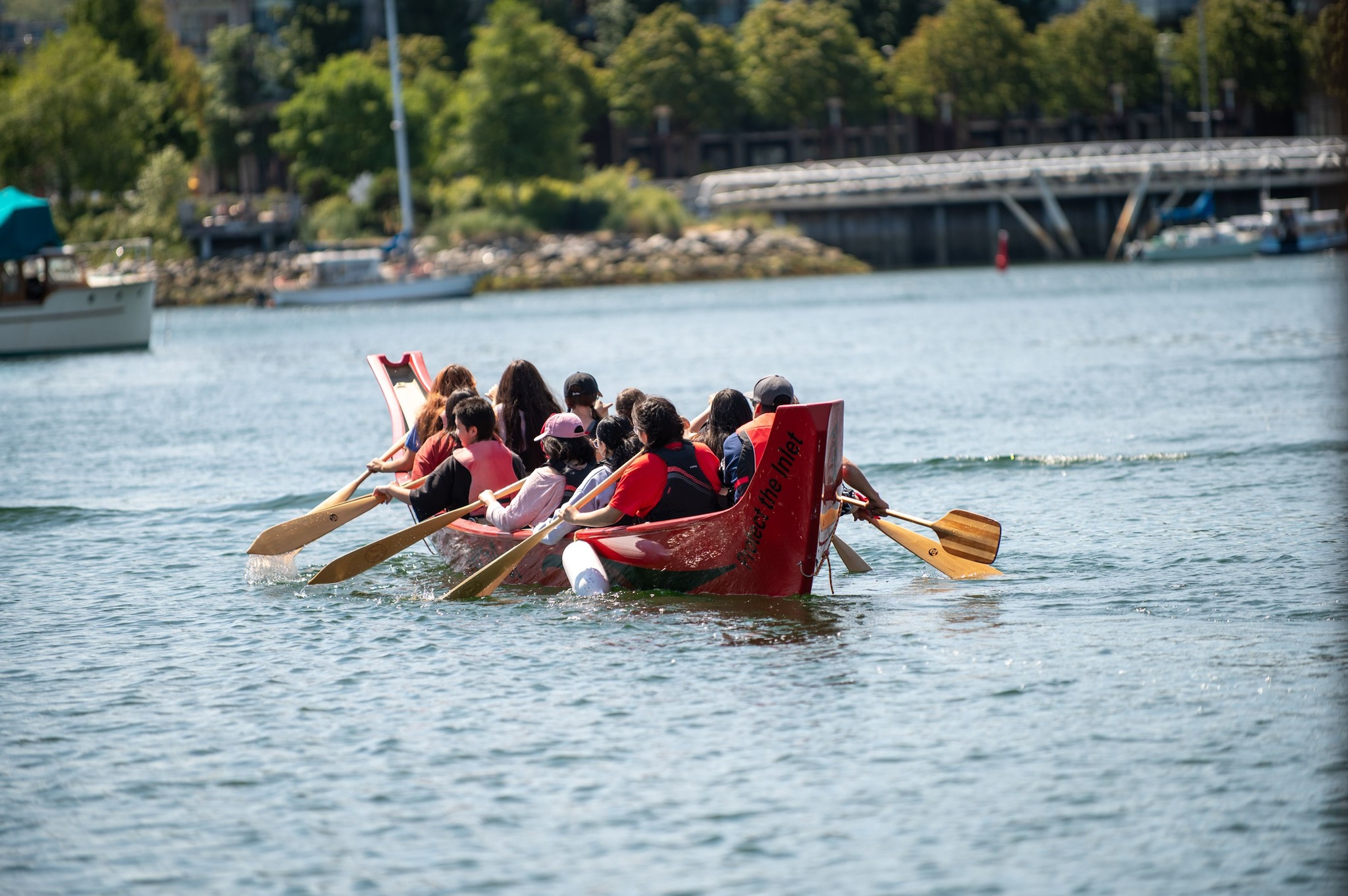 Canoe Cultures tour with guests paddling a canoe in water