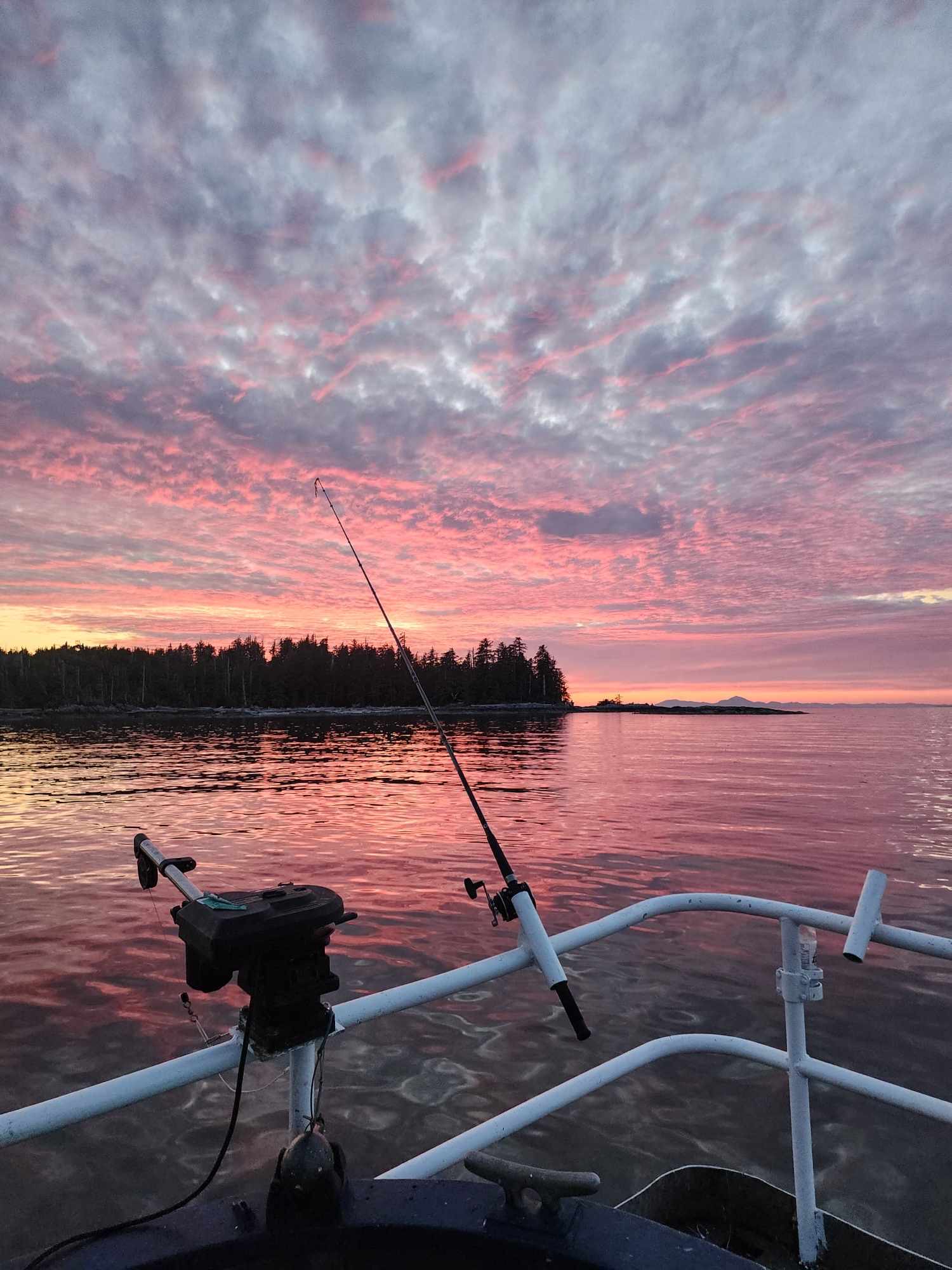 Sunset sky seen from D & L Fishing Charters boat with fishing rods