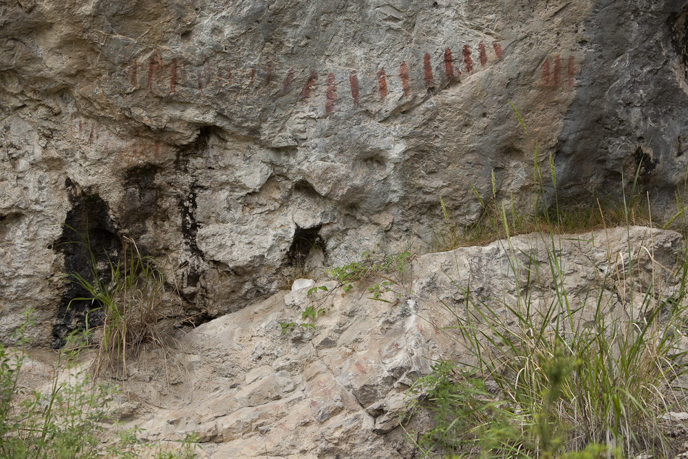 A rock wall with red and black markings