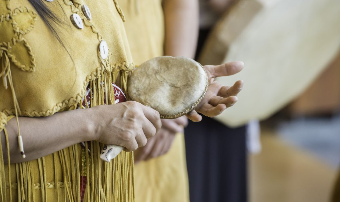 Up close image of a woman playing a shaker.