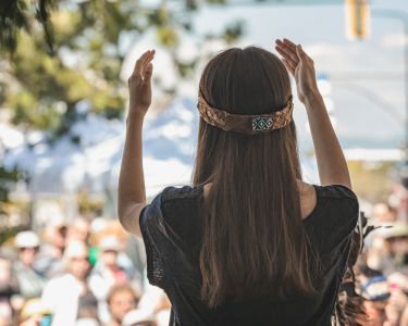 Woman standing in front of a crowd of spectators