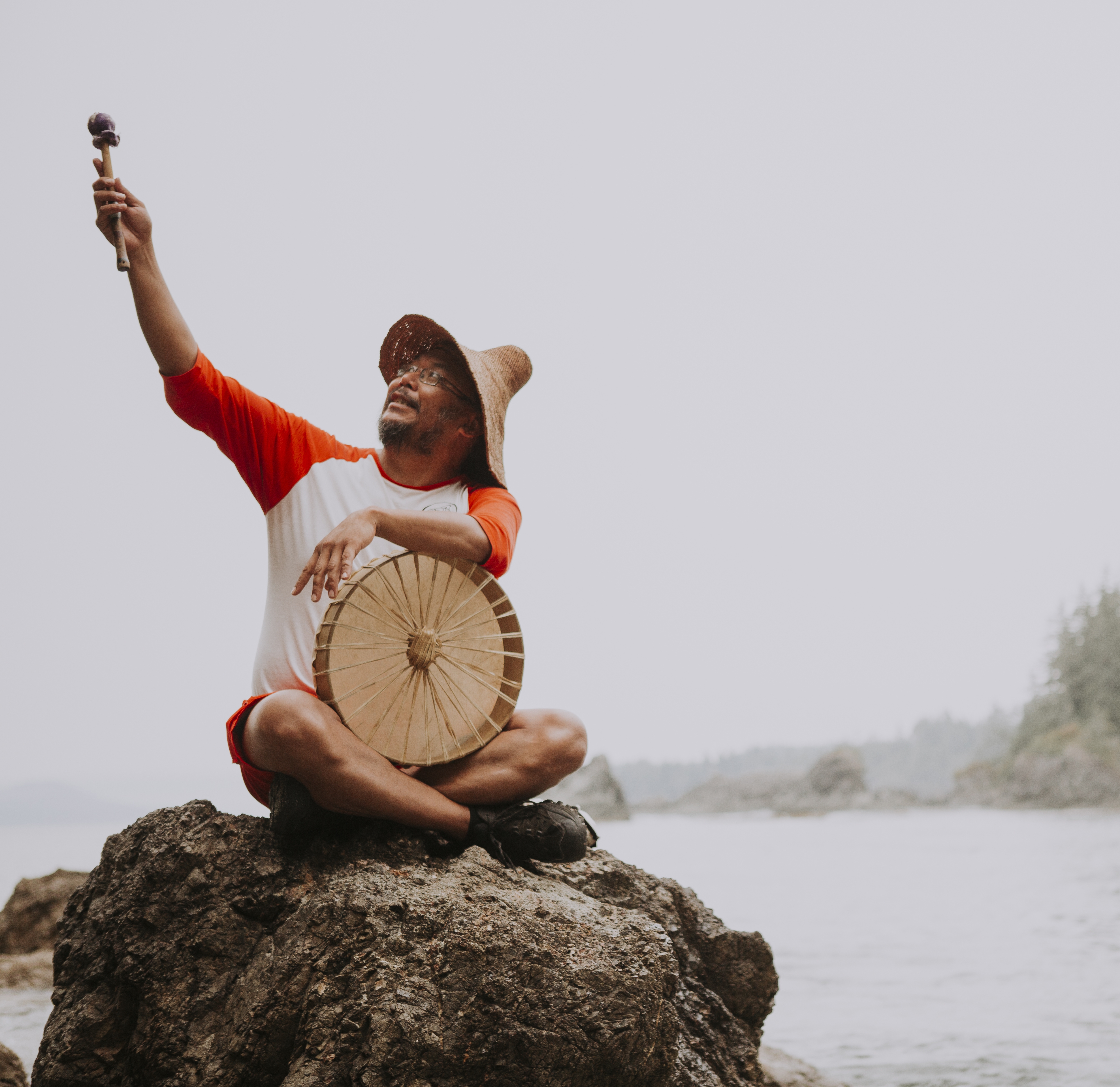 Man on a rock with a drum