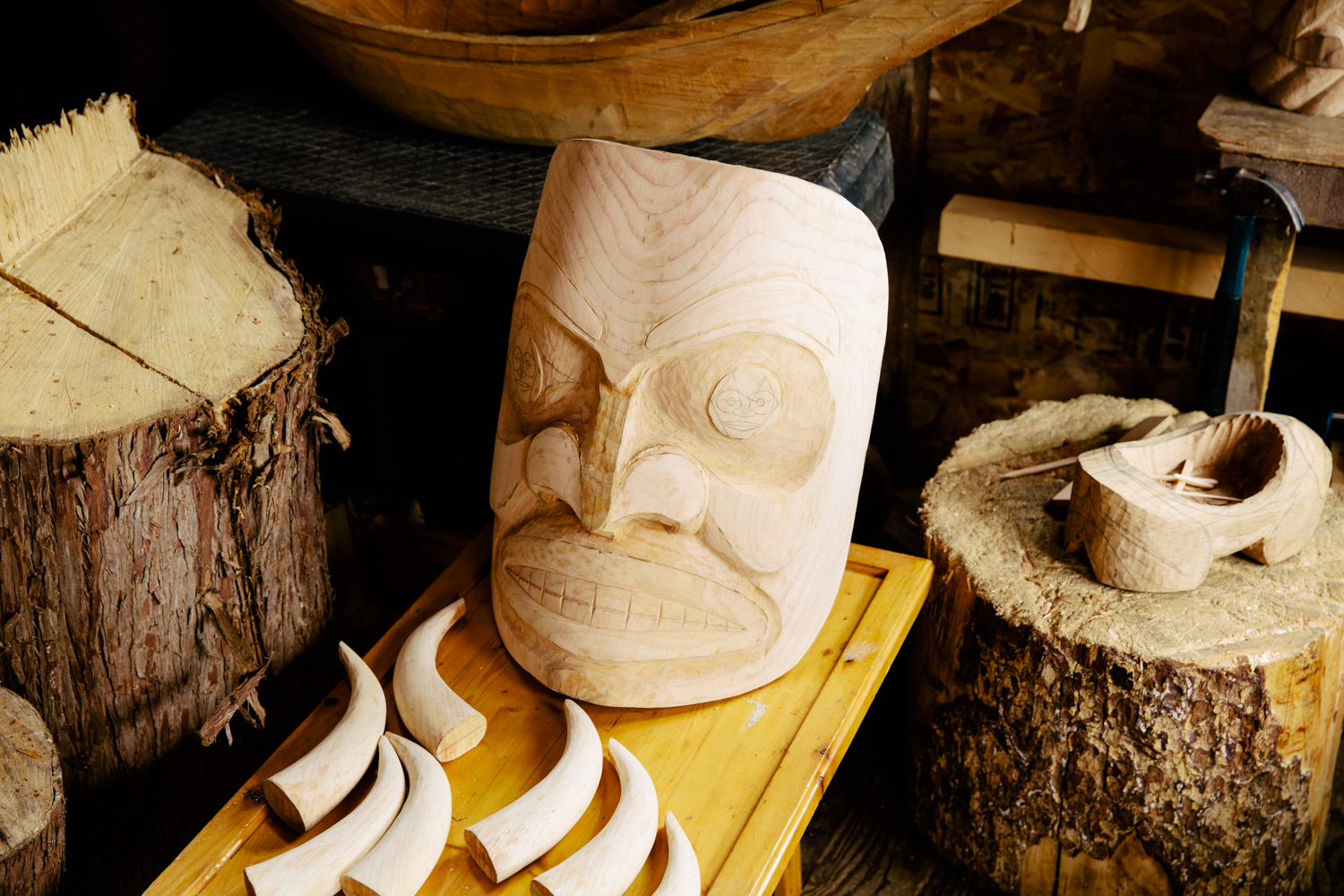 Mask being carved out of wood.