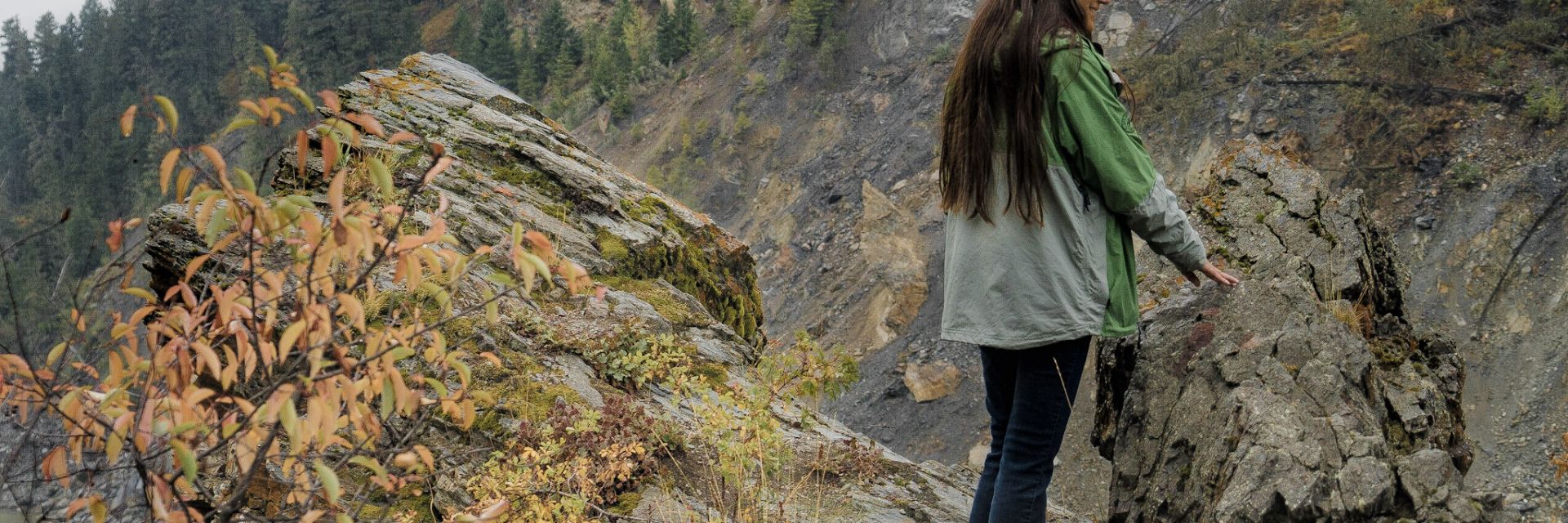 Person standing amongst rocks in the mountains